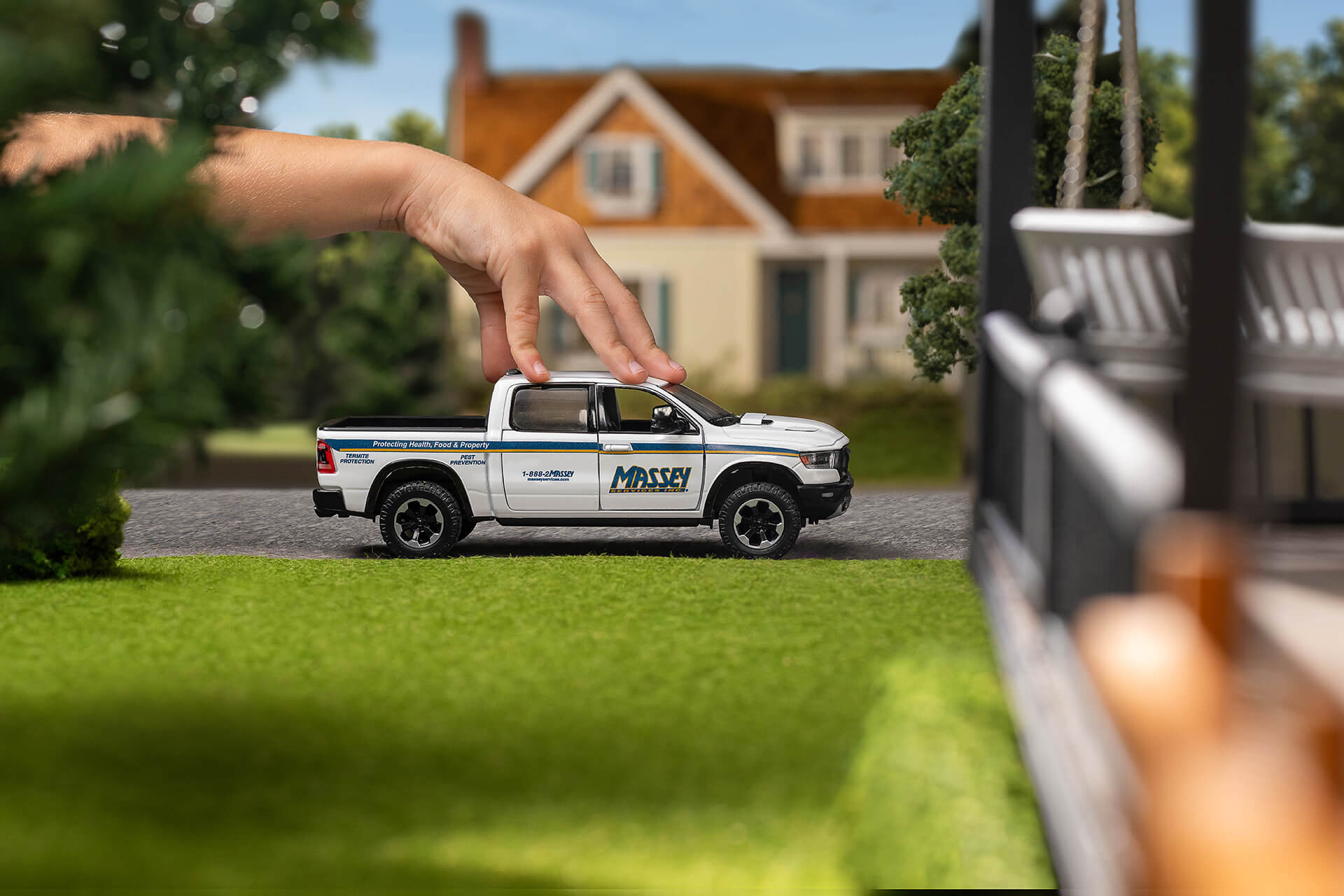 Massey Services vehicle outside a house, framed by trees and a lawn.