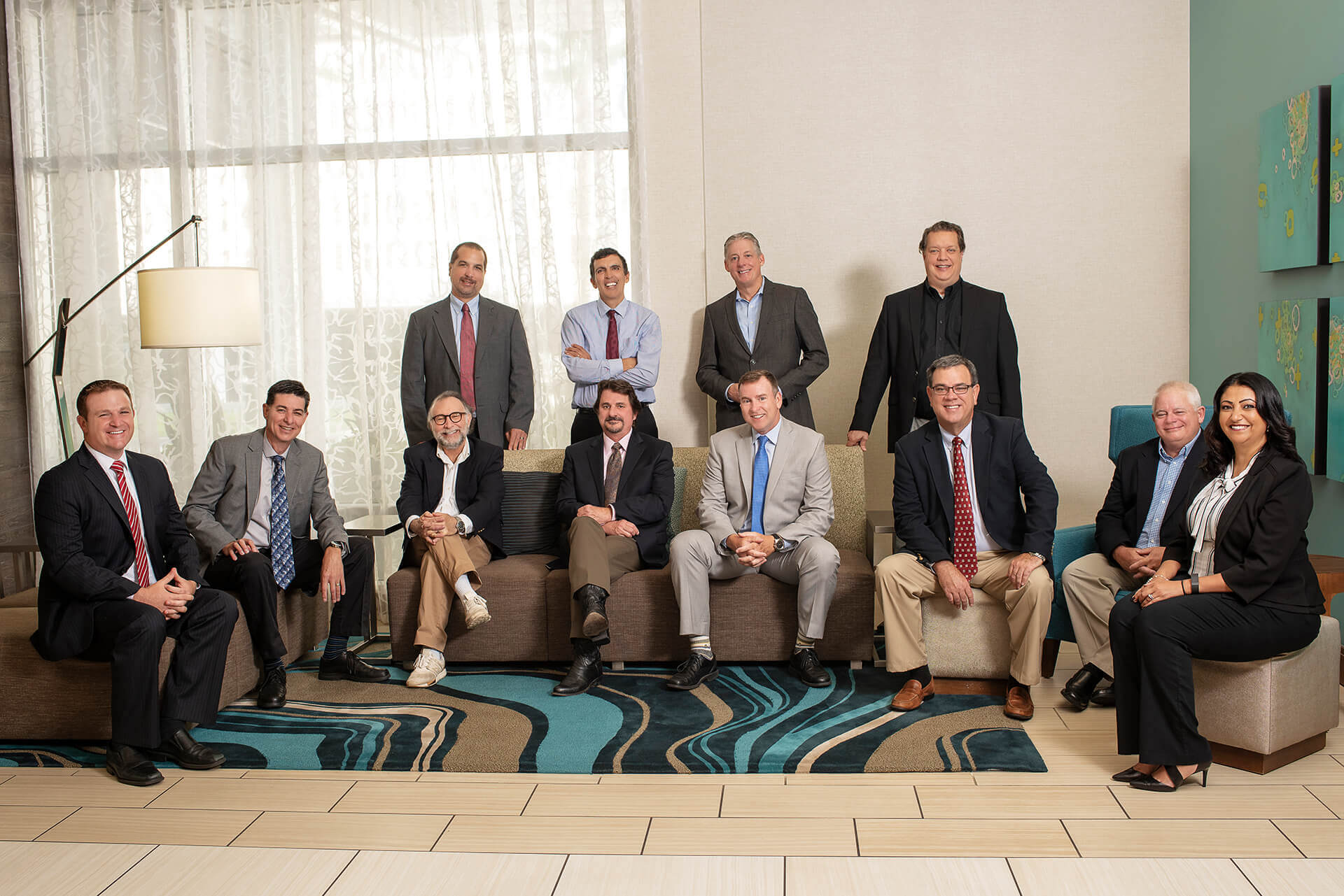TLC Engineering Solutions team arranged together in a bright modern lobby.